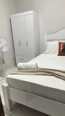 a white bedroom with a bed and a white cabinet at T2 Vacation in Mindelo in Mindelo