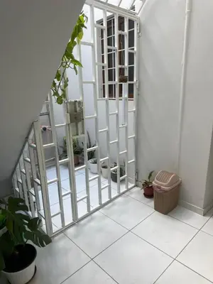 a room with a white gate and some plants at T2 Vacation in Mindelo in Mindelo