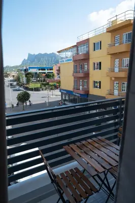 a wooden bench sitting on top of a balcony at Apart'hotel Assomada in Assomada