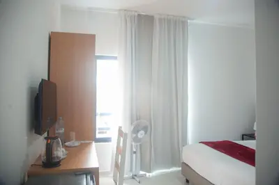 a bedroom with a bed and a desk and a window at Apart'hotel Assomada in Assomada