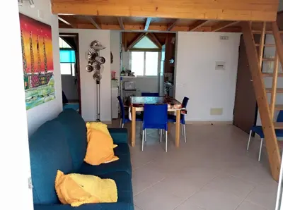 a living room with a blue couch and a table at Soleil A5 - Lovely and central apartment in Santa Maria
