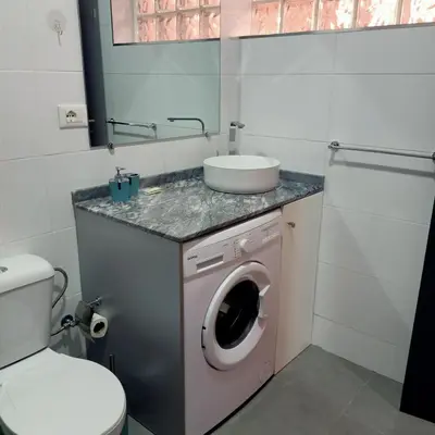 a bathroom with a washing machine and a sink at Ca' Estrella Santa Maria Sal in Santa Maria