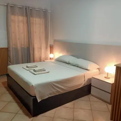 a bedroom with a bed with two lamps on it at Ca' Estrella Santa Maria Sal in Santa Maria