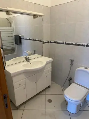 a bathroom with a sink and a toilet at Condominio atlantico ll in Praia