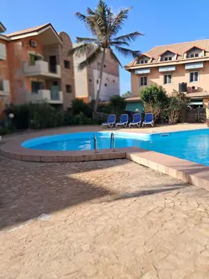 a swimming pool in front of a house with chairs at Cà Giasone in Santa Maria