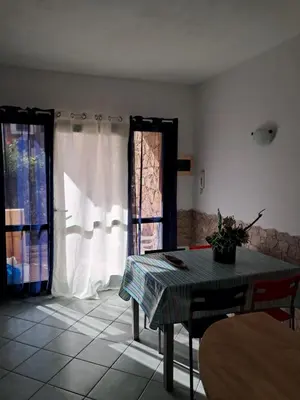 a living room with a table and a window at Cà Giasone in Santa Maria