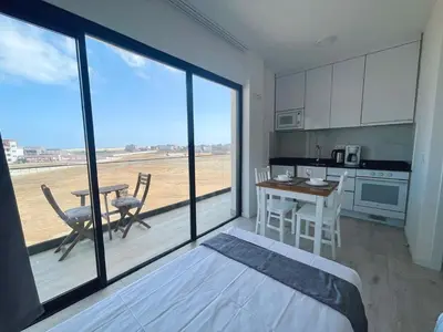 a room with a bed and a kitchen with a table at Studio Medsal in Santa Maria