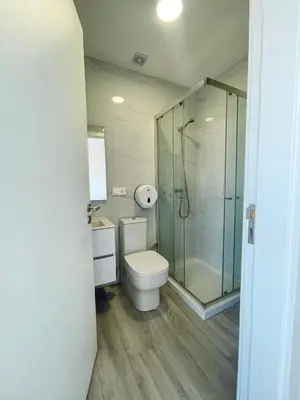 a bathroom with a toilet and a glass shower at Studio Medsal in Santa Maria