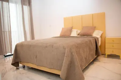 a bedroom with a large bed with a wooden headboard at Fresh One Apartment in Praia
