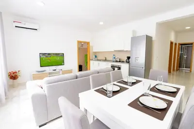 a living room with a couch and a table at New building - 1 min away from the main road in Santa Maria