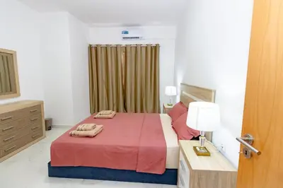 a bedroom with a bed with two towels on it at New building - 1 min away from the main road in Santa Maria