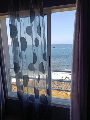 a window with a view of the beach and the ocean at B&B Casa Boho