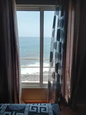 a bedroom window with a view of the ocean at B&B Casa Boho