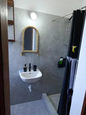 a bathroom with a sink and a mirror at B&B Casa Boho