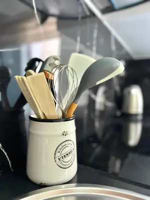a container filled with cooking utensils on a counter at Salinas Breeze in Santa Maria