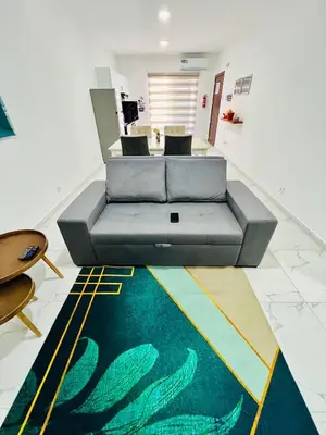 a couch sitting on a rug in a living room at Salinas Breeze in Santa Maria