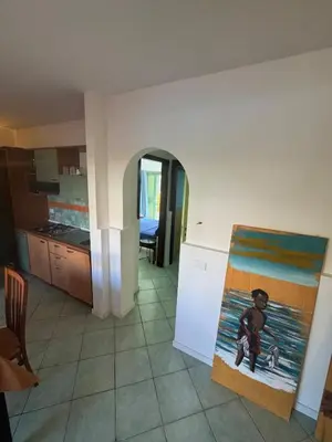a kitchen with a painting of a boy on the beach at Holiday Properties Djadsal Pirata - Wi-fi in Santa Maria