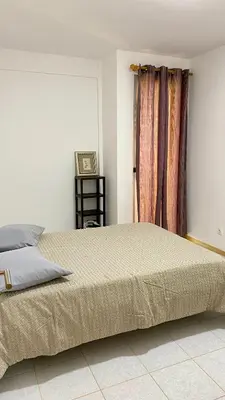 a bedroom with a large bed and a window at Airport Residence - Vila Acácia I in Praia