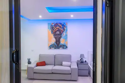 a living room with a white couch and a painting at Yes Rooftop, Private Pool & Sea View, Cidadela in Praia