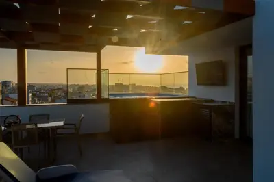 a room with a table and a view of a city at Yes Rooftop, Private Pool & Sea View, Cidadela in Praia