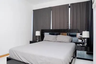 a bedroom with a white bed and a window at Kretxeu Luxury Villa in Praia