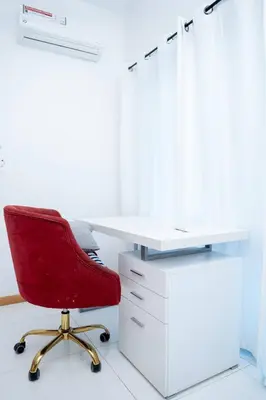 an office with a red chair and a white desk at Kretxeu Luxury Villa in Praia