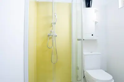 a bathroom with a shower and a toilet at Kretxeu Luxury Villa in Praia