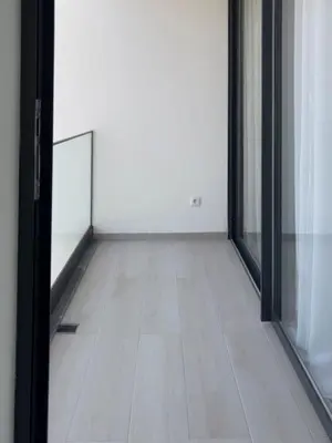 an empty room with a mirror and a wooden floor at 2-bdr bright apt central street cidadela - LCGR in Praia