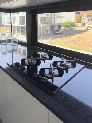 a stove top in a kitchen with a window at 2-bdr bright apt central street cidadela - LCGR in Praia