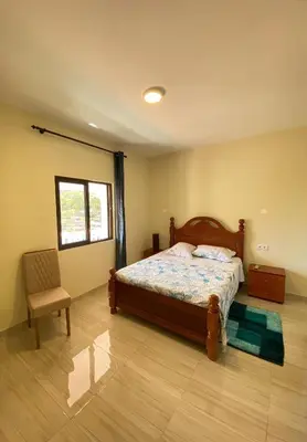 a bedroom with a bed and a chair and a window at Residencial Palice