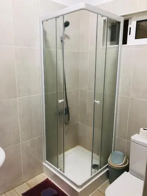 a shower with a glass door in a bathroom at Residencial Palice