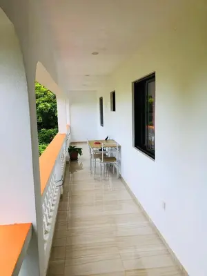 a hallway of a house with a table and chairs at Residencial Palice