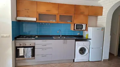 a kitchen with a sink and a stove and a refrigerator at Star House Murdeira, Sal Island, Cape Verde in Beirona