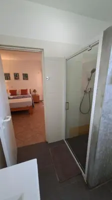 a bathroom with a shower and a bedroom with a bed at Star House Murdeira, Sal Island, Cape Verde in Beirona