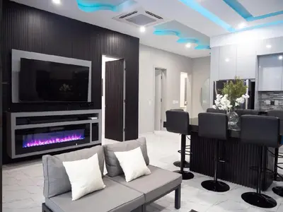 a living room with a couch and a fireplace and a tv at Top-Level Pool in Praia