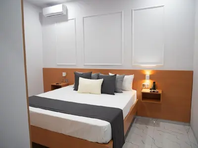 a bedroom with a large bed with two windows at Top-Level Pool in Praia