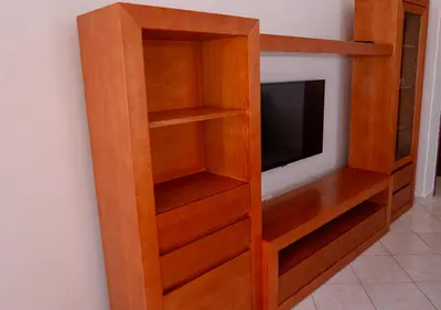 a wooden book shelf with a television in it at Residencial Mendes in Tarrafal