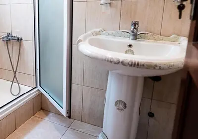 a bathroom with a sink and a shower at Residencial Mendes in Tarrafal