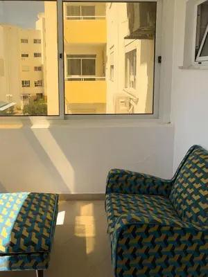 a living room with a chair and a window at Spacious 3-bdr apt seafront, exterior pool - LCGR in Praia