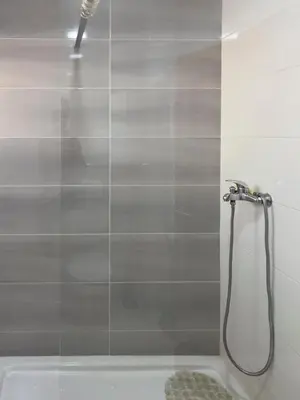 a shower in a bathroom with a glass door at Spacious 3-bdr apt seafront, exterior pool - LCGR in Praia