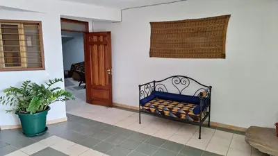 a blue bench in a room with a door at Kaza Manata in Praia