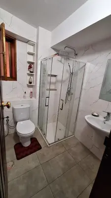 a bathroom with a shower and a toilet and a sink at Kaza Manata in Praia