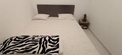 a bed in a room with a zebra blanket on it at Casa Azul in Paul