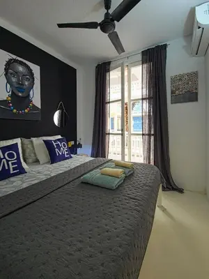 a bedroom with a large bed and a window at Casa Albacora in Sal Rei