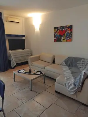 a living room with a couch and a table at Moradias No Stress in Santa Maria