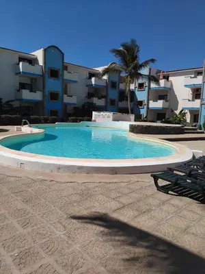 a large swimming pool in front of a building at Moradias No Stress in Santa Maria