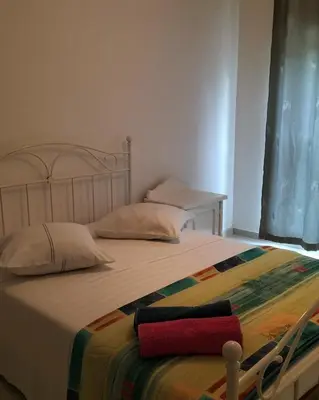 a bedroom with a bed with a blanket on it at Cozyapartment Povoacao, Rbra GrandeSanto Antao in Ribeira Grande