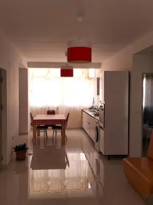 a small kitchen with a table and a refrigerator at Cozyapartment Povoacao, Rbra GrandeSanto Antao in Ribeira Grande