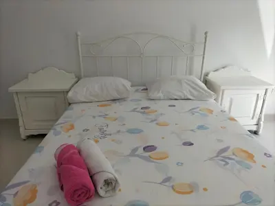 a bed with towels and pillows on it at Cozyapartment Povoacao, Rbra GrandeSanto Antao in Ribeira Grande