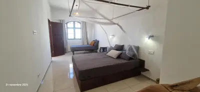 a bedroom with a bed and a chair in a room at Casa Cesaria Guest House in Sal Rei